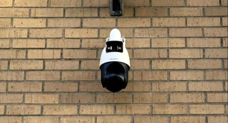 Outdoor security camera installation on brown brick wall